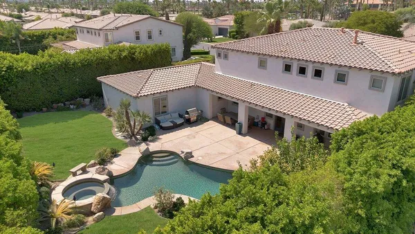 a view of a white building with a swimming pool
