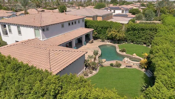 a view of a patio with table and chairs with wooden floor and fence