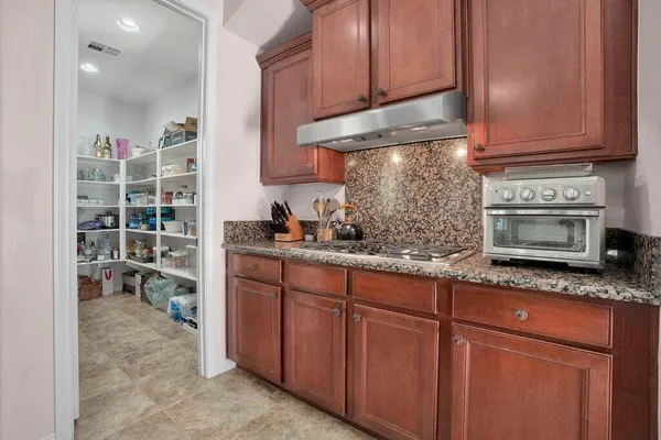 a living room with furniture a chandelier and a dining table