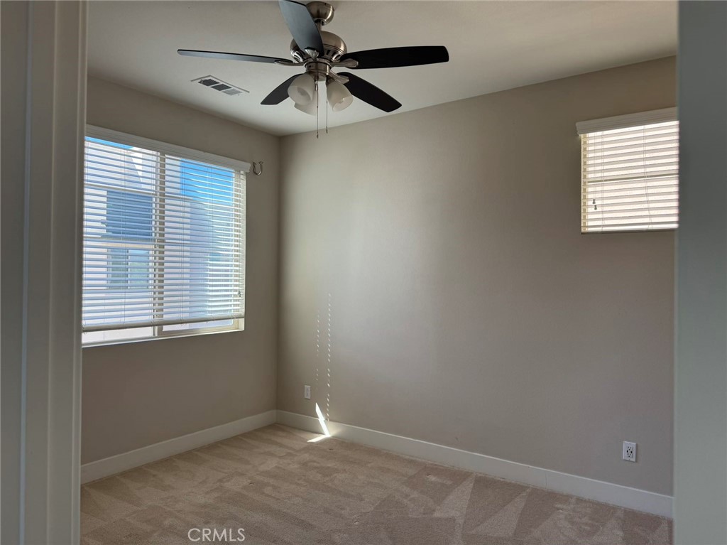 171 Interval Irvine, CA 92618 - Photo 14 of 19 an empty room with windows and fan