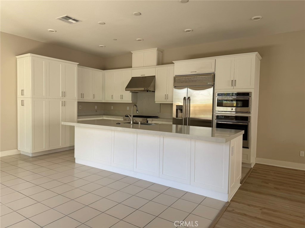 171 Interval Irvine, CA 92618 - Photo 2 of 19 a kitchen with stainless steel appliances granite countertop a refrigerator and a stove