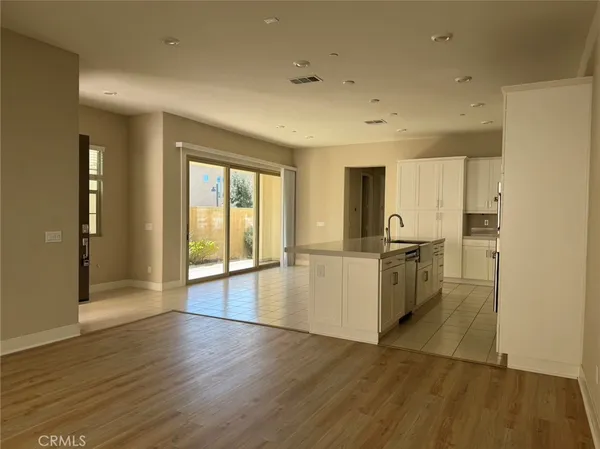a view of open kitchen with wooden floor and electronic appliances