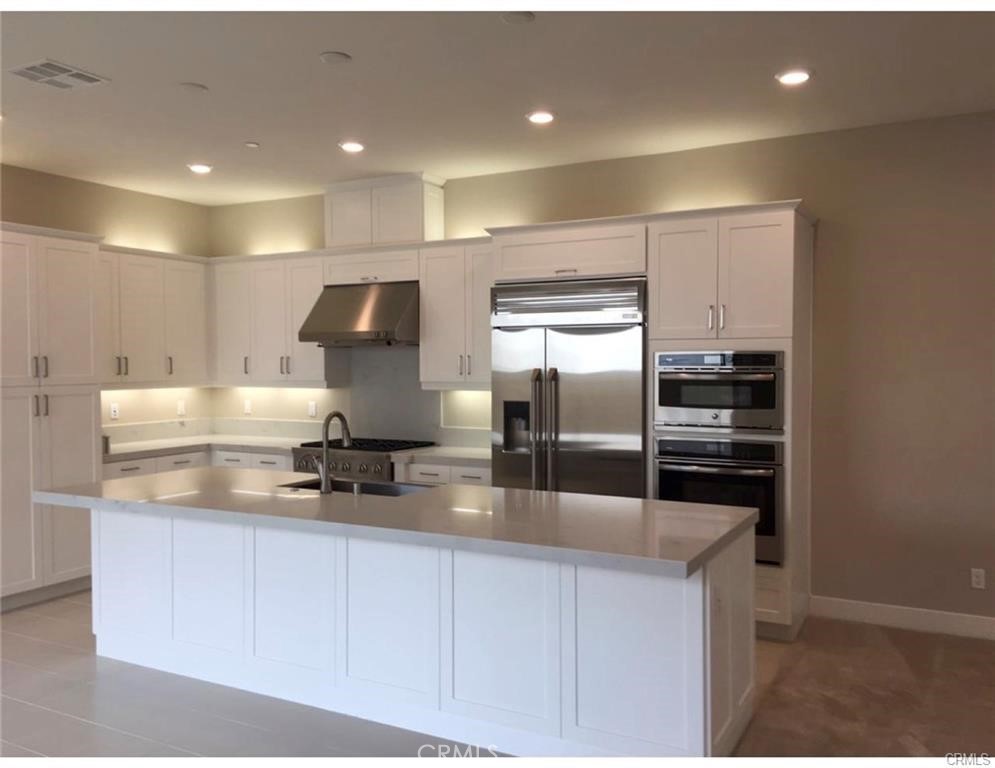 171 Interval Irvine, CA 92618 - Photo 3 of 8 a kitchen with kitchen island a counter top space cabinets and stainless steel appliances