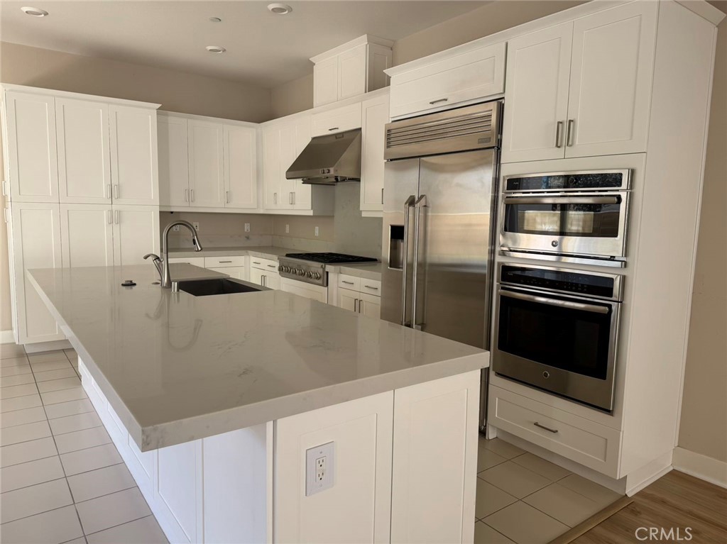 171 Interval Irvine, CA 92618 - Photo 4 of 19 a kitchen with appliances a sink and cabinets