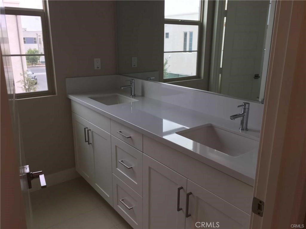 171 Interval Irvine, CA 92618 - Photo 4 of 8 a bathroom with a sink and a window