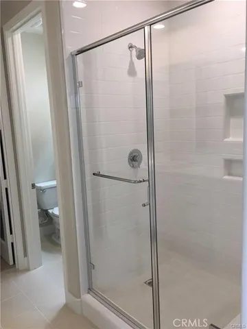 a bathroom with a shower and a toilet