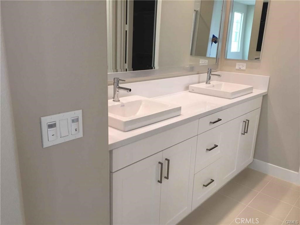 171 Interval Irvine, CA 92618 - Photo 6 of 8 a bathroom with a sink and a mirror