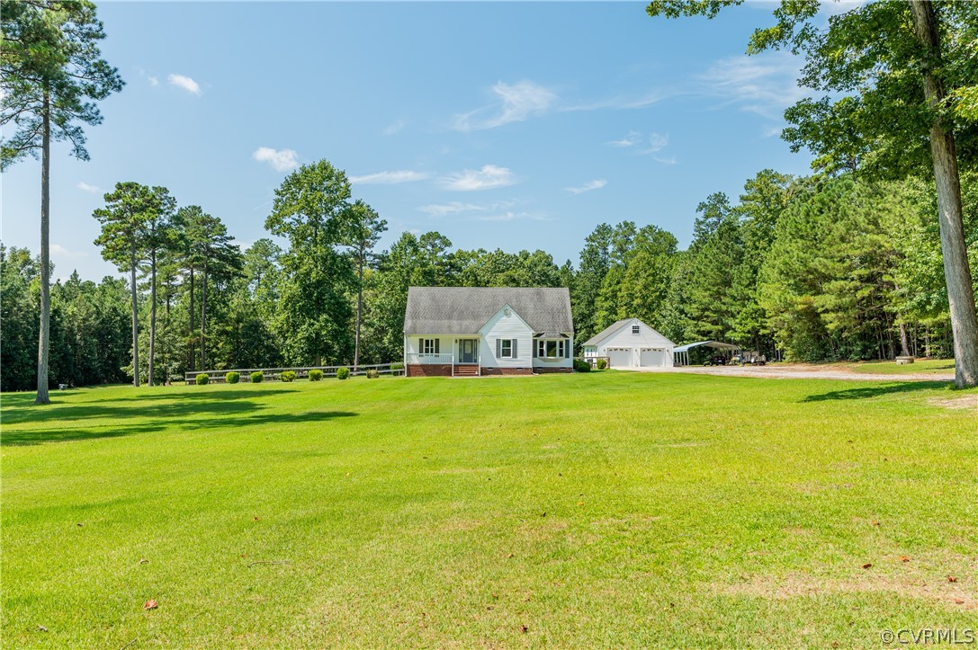 19070 Halifax Road Carson, VA 23830 - Photo 1 of 43 a front view of a house with a yard and trees