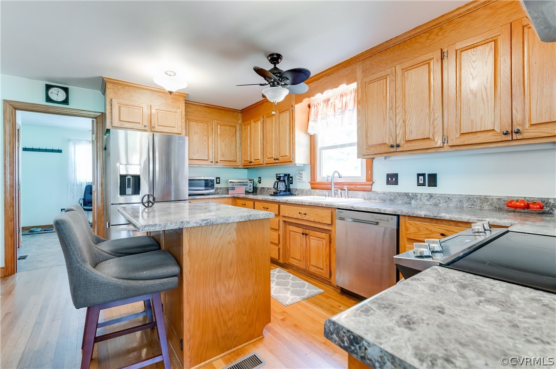 19070 Halifax Road Carson, VA 23830 - Photo 12 of 43 a kitchen with stainless steel appliances granite countertop a stove a sink and a refrigerator