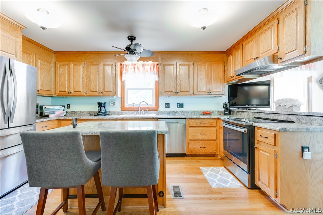 19070 Halifax Road Carson, VA 23830 - Photo 13 of 43 a kitchen with stainless steel appliances granite countertop a stove a sink a microwave a refrigerator and cabinets