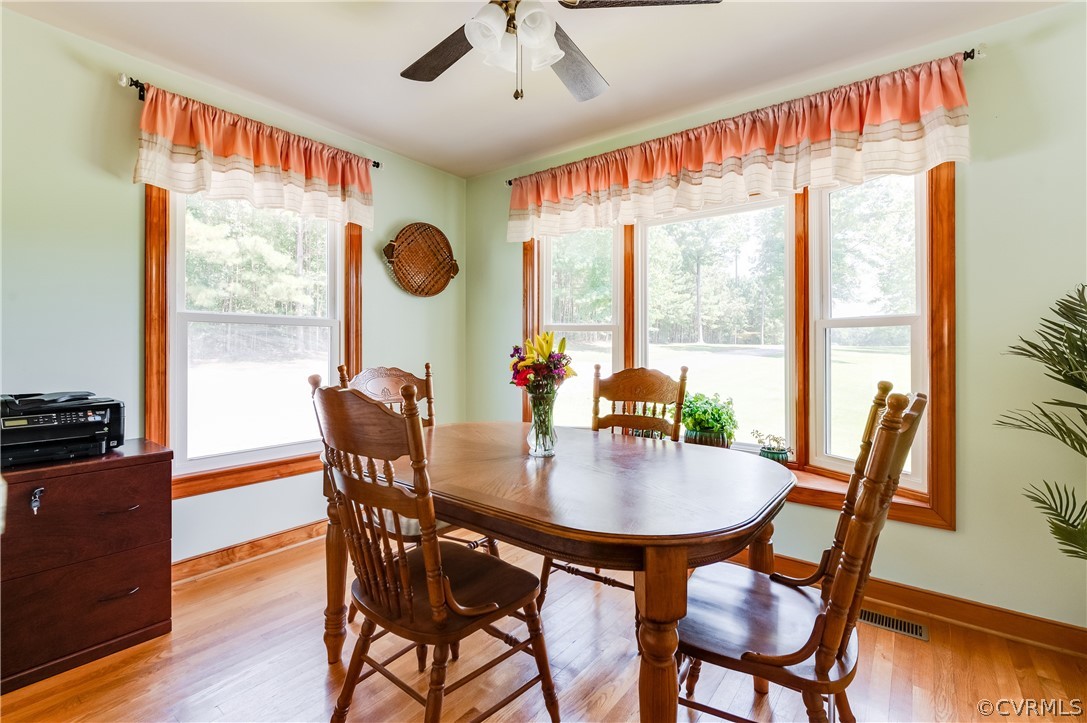 19070 Halifax Road Carson, VA 23830 - Photo 16 of 43 a dining room with furniture a chandelier and wooden floor