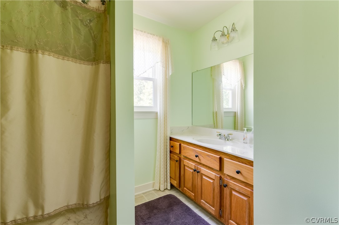 19070 Halifax Road Carson, VA 23830 - Photo 28 of 43 a bathroom with a double vanity sink and mirror