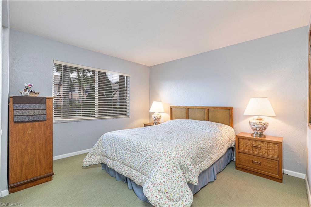 3832 Snowflake Lane, Unit 1207 Naples, FL 34112 - Photo 15 of 22 a bedroom with a bed and a window