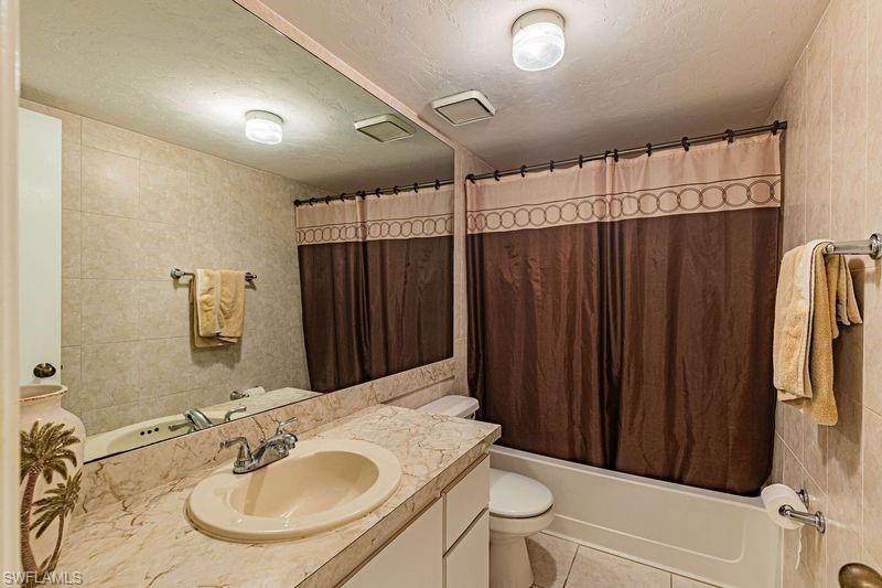 3832 Snowflake Lane, Unit 1207 Naples, FL 34112 - Photo 16 of 22 a bathroom with a sink and a mirror