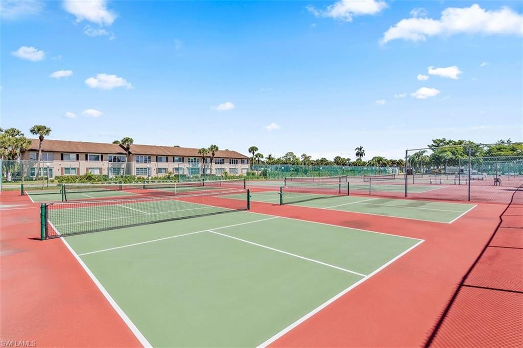 3832 Snowflake Lane, Unit 1207 Naples, FL 34112 - Photo 19 of 22 a view of an outdoor space and tennis court