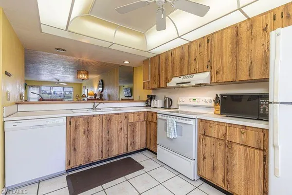 a dining room with furniture and floor to ceiling window