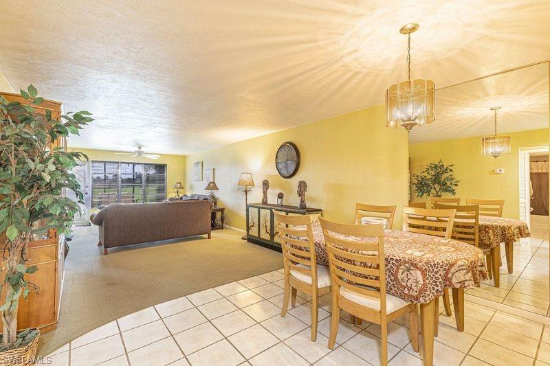 3832 Snowflake Lane, Unit 1207 Naples, FL 34112 - Photo 5 of 22 a view of a swimming pool and outdoor seating