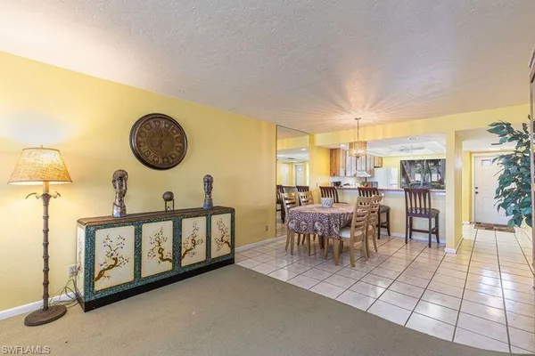 a dining room with furniture and a floor to ceiling window