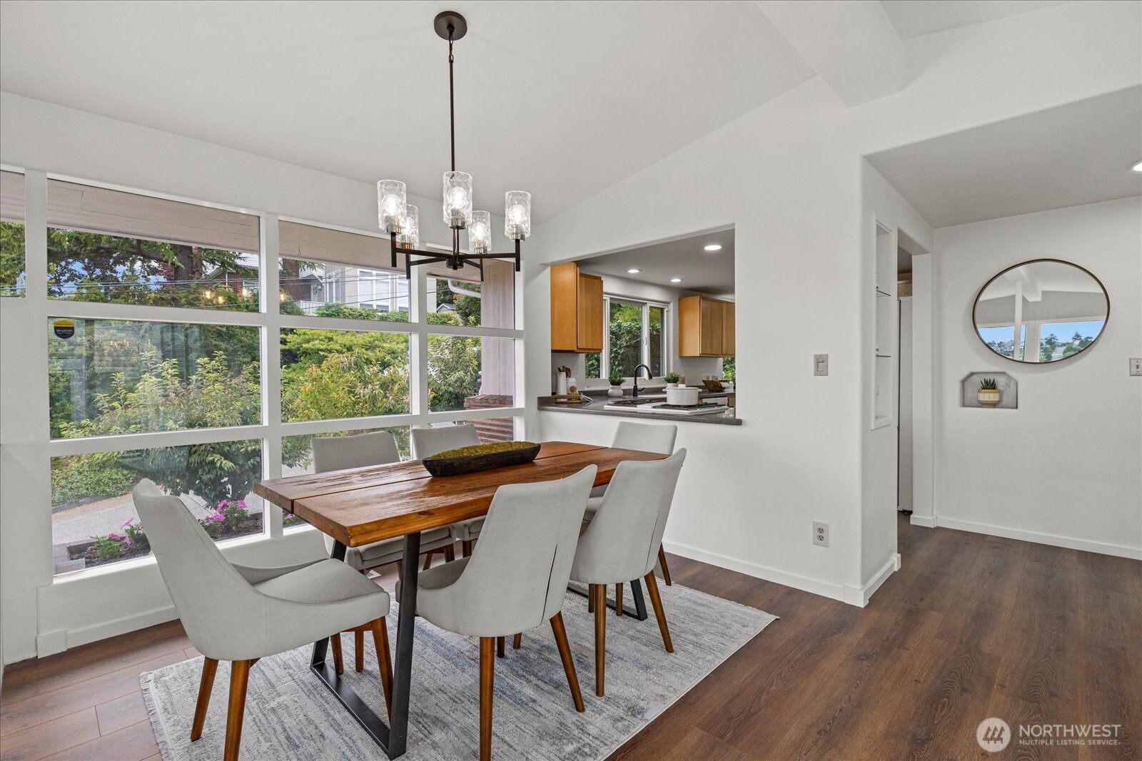 2819 West McGraw Street Seattle, WA 98199 - Photo 11 of 40 a dining room with furniture a chandelier and wooden floor