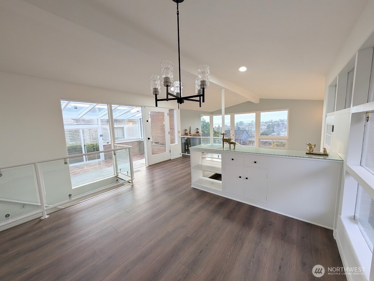 2819 West McGraw Street Seattle, WA 98199 - Photo 12 of 40 a large kitchen with lots of counter space wooden floor and stainless steel appliances