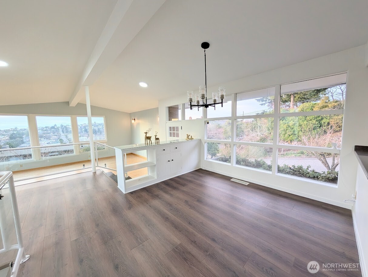 2819 West McGraw Street Seattle, WA 98199 - Photo 13 of 40 a room with window and wooden floor