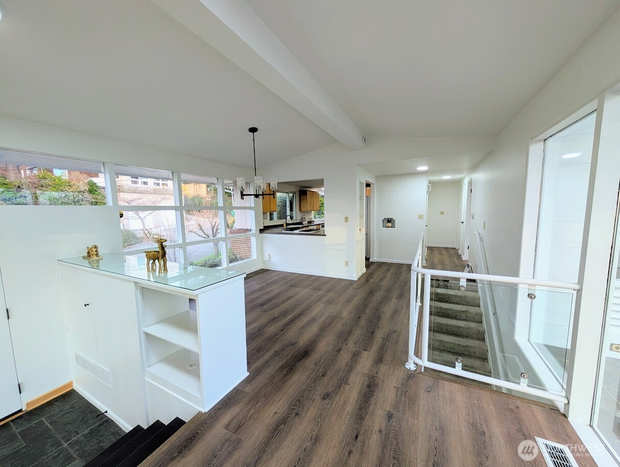 2819 West McGraw Street Seattle, WA 98199 - Photo 14 of 40 a open kitchen with white cabinets and wooden floor