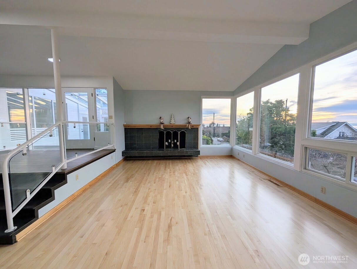 2819 West McGraw Street Seattle, WA 98199 - Photo 15 of 40 a view of an empty room with a window and wooden floor
