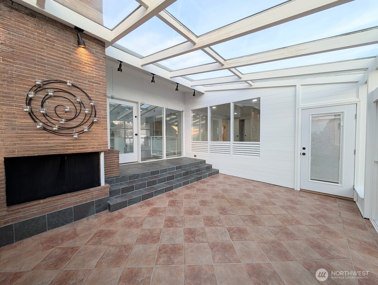 2819 West McGraw Street Seattle, WA 98199 - Photo 21 of 40 a view of empty room with a fireplace and fan