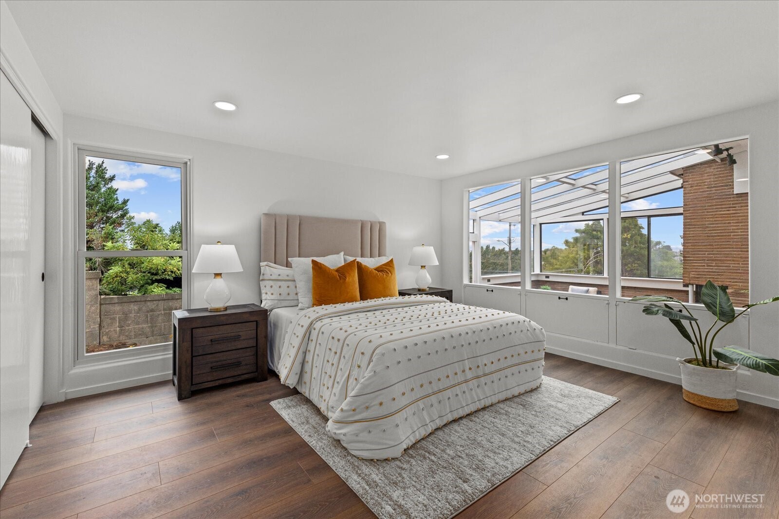 2819 West McGraw Street Seattle, WA 98199 - Photo 22 of 40 a bedroom with a large bed and windows