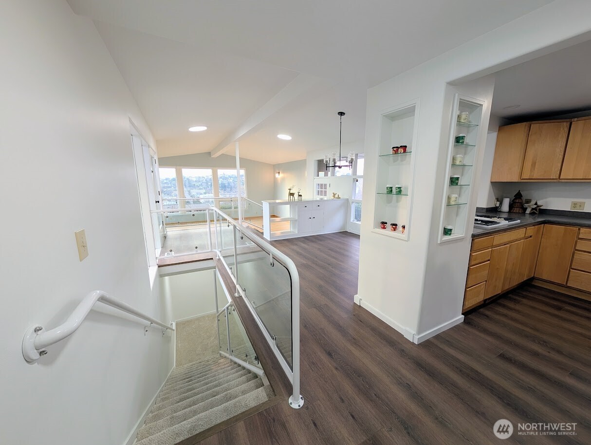 2819 West McGraw Street Seattle, WA 98199 - Photo 9 of 40 a view of a kitchen with kitchen island wooden floors appliances and a sink