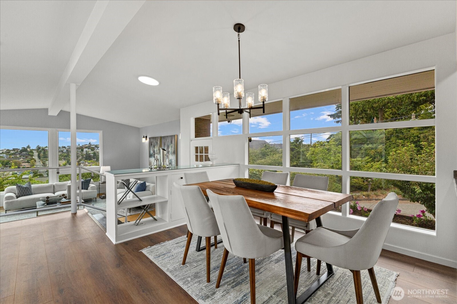 2819 West McGraw Street Seattle, WA 98199 - Photo 10 of 40 a dining room with furniture a chandelier and wooden floor