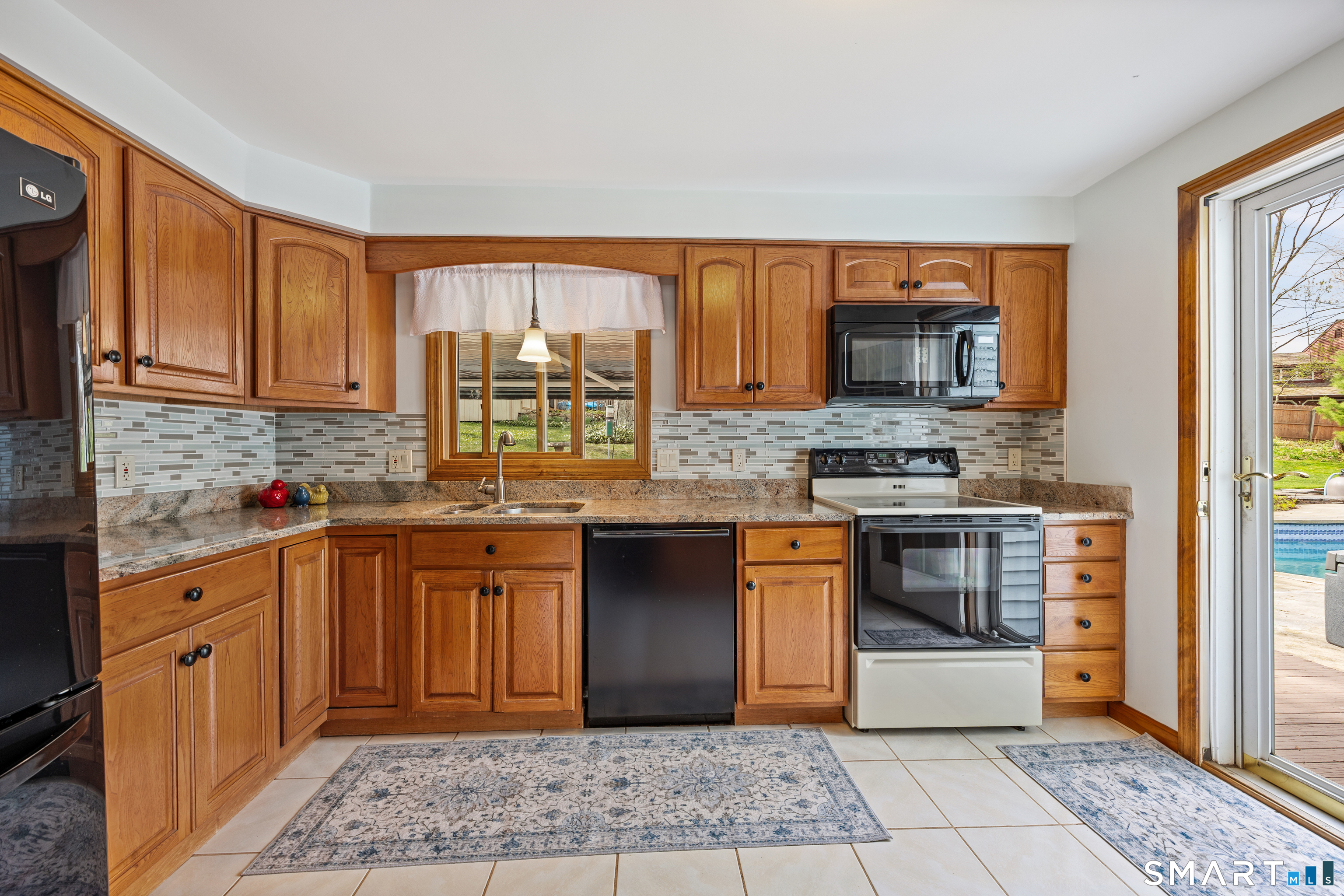 42 Chimney Sweep Road Wallingford, CT 06492 - Photo 12 of 40 a kitchen with stainless steel appliances granite countertop a stove a sink and a microwave