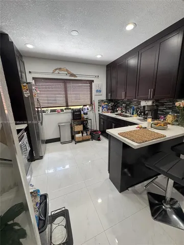 a kitchen with a sink appliances and cabinets