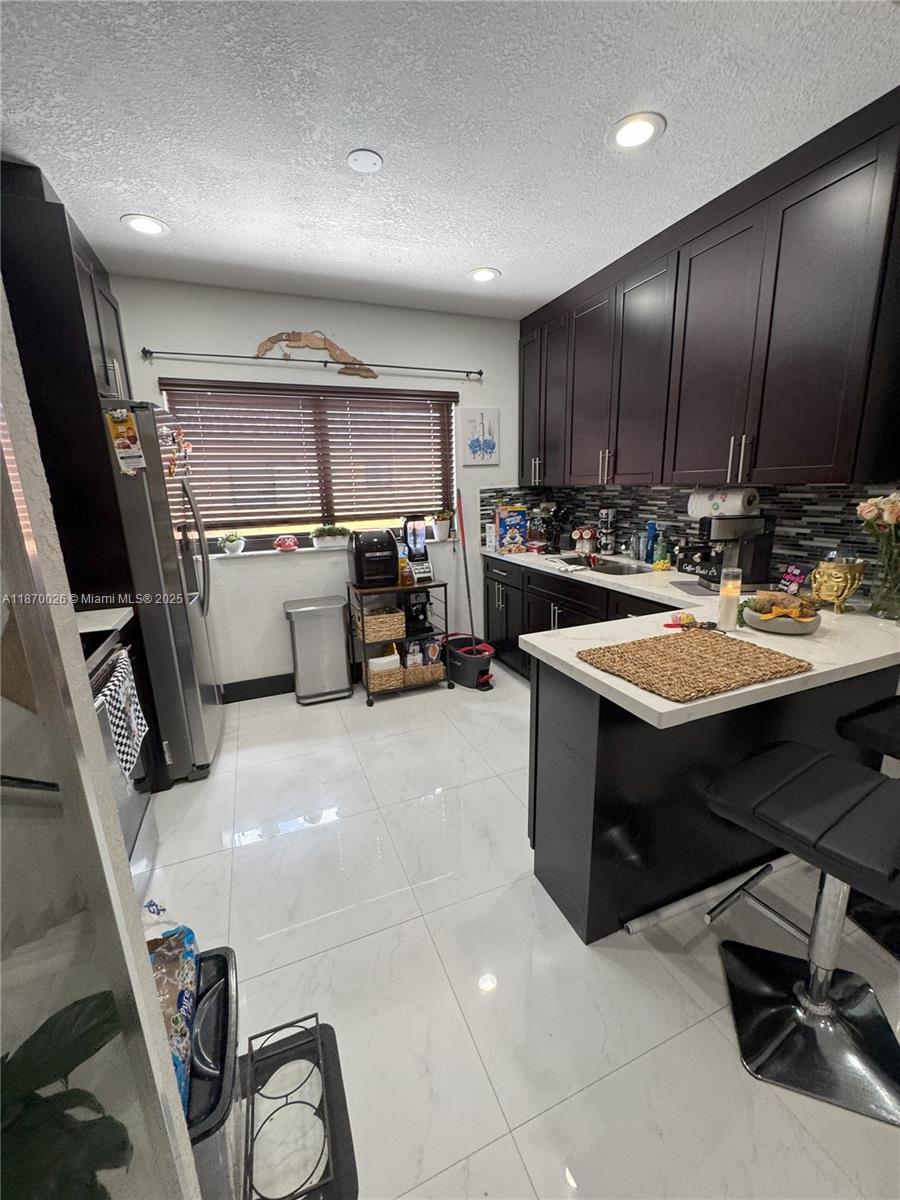6411 West 27th Way, Unit 201 Hialeah, FL 33016 - Photo 2 of 21 a kitchen with a sink appliances and cabinets