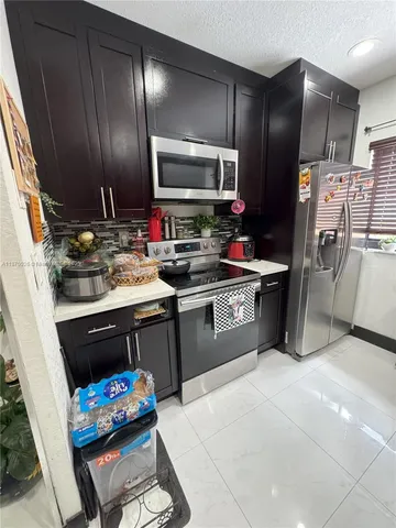 a kitchen with a sink stainless steel appliances and cabinets