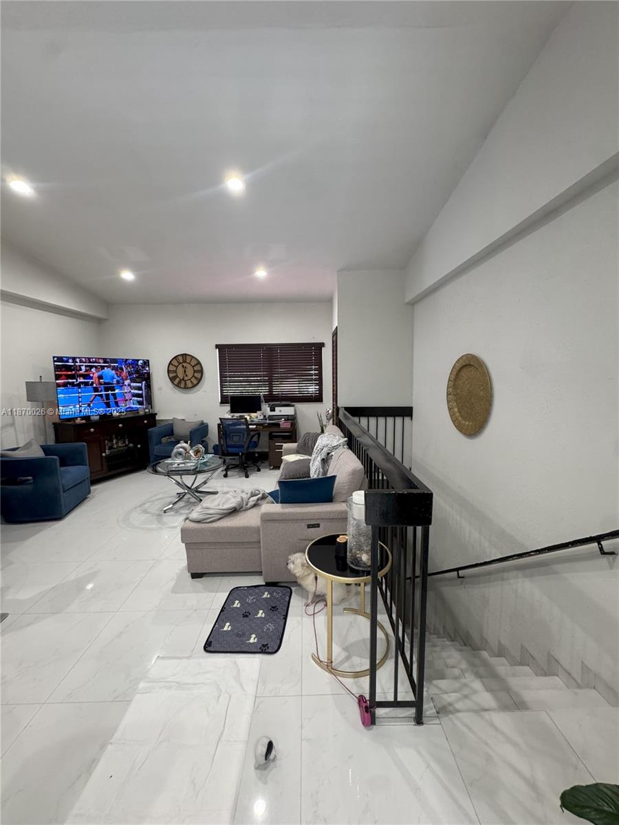 6411 West 27th Way, Unit 201 Hialeah, FL 33016 - Photo 6 of 21 a living room with furniture and a window