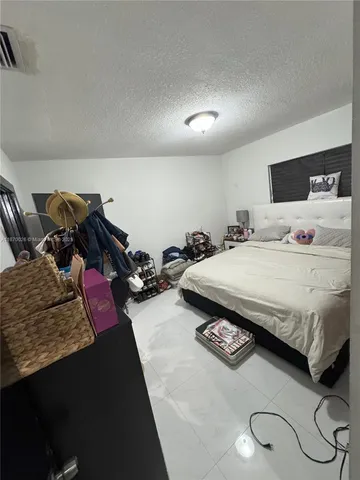 a bedroom with a bed and a night stand