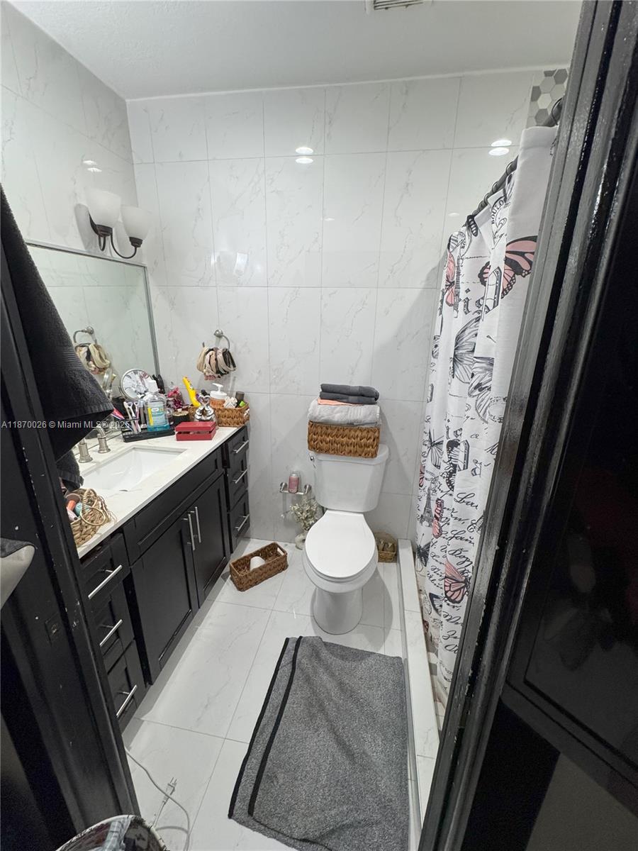 6411 West 27th Way, Unit 201 Hialeah, FL 33016 - Photo 10 of 21 a bathroom with a sink toilet and shower