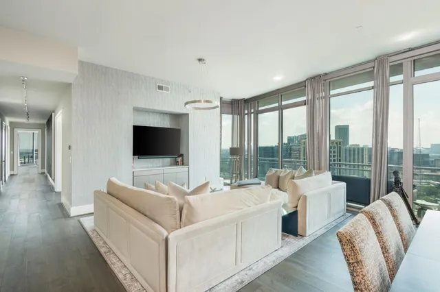 a living room with furniture and a chandelier