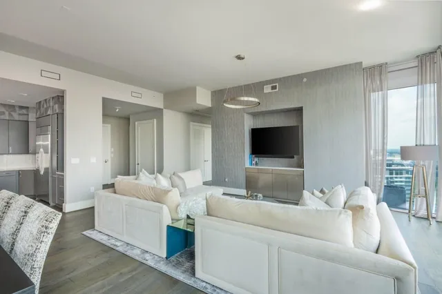 a living room with furniture a rug and a flat screen tv