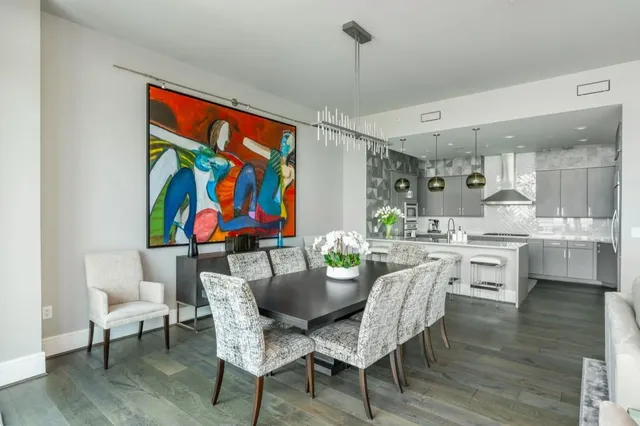 a view of a dining room with furniture large windows and wooden floor