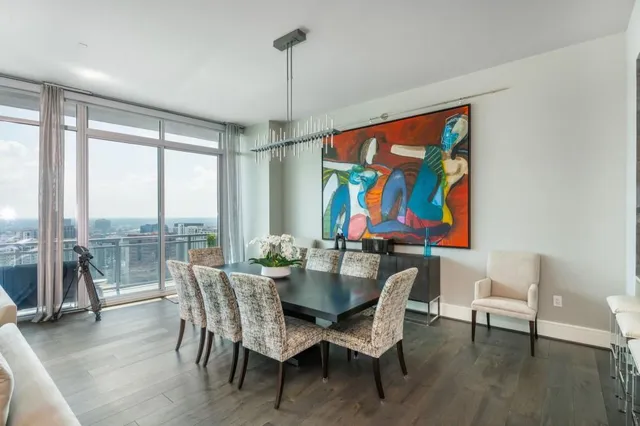 a kitchen with stainless steel appliances granite countertop a sink a stove and a wooden floors