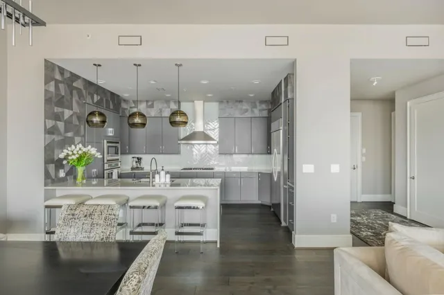 a view of a hallway with wooden floor and closet