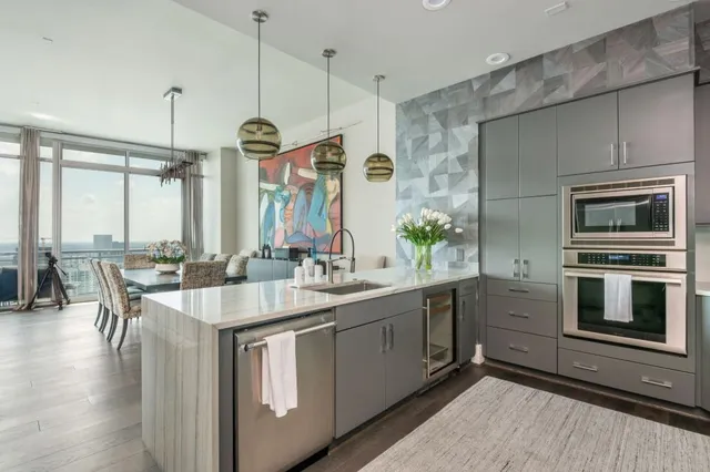 a large white kitchen with a large window