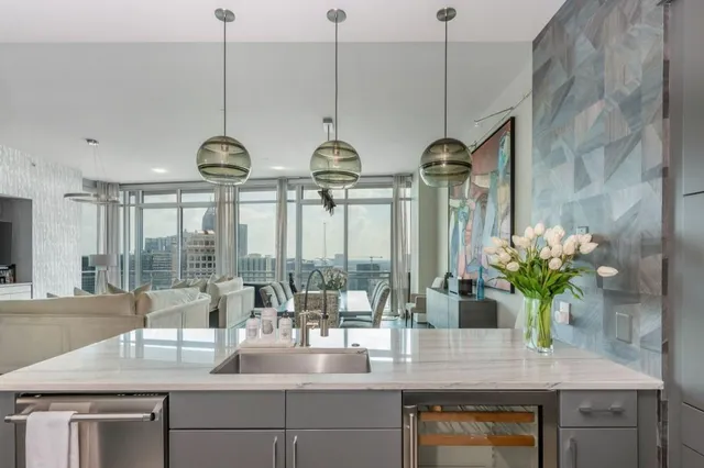 a living room with furniture and a floor to ceiling window