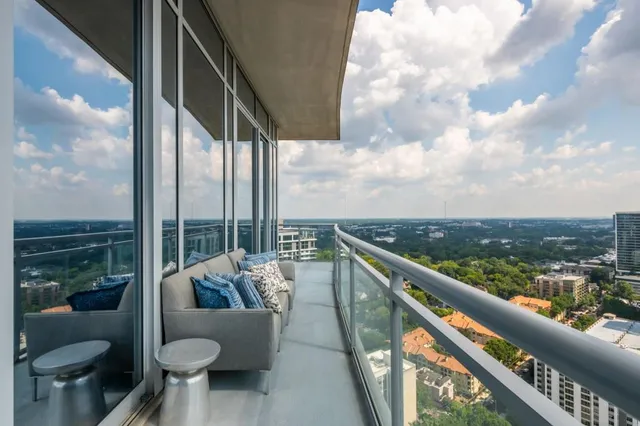 a living room with furniture and a painting on the wall