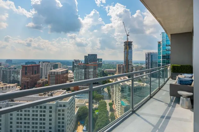 a living room with furniture and a painting on the wall