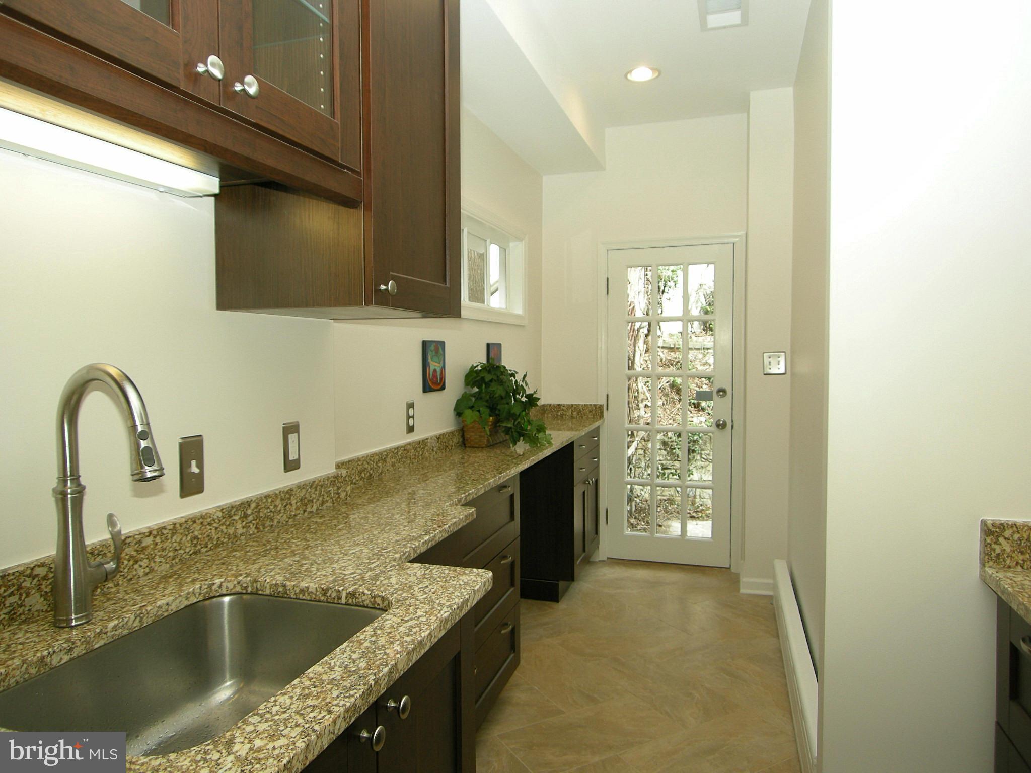 2815 Woodley Road Northwest Washington, DC 20008 - Photo 12 of 25 a kitchen with a sink and a refrigerator