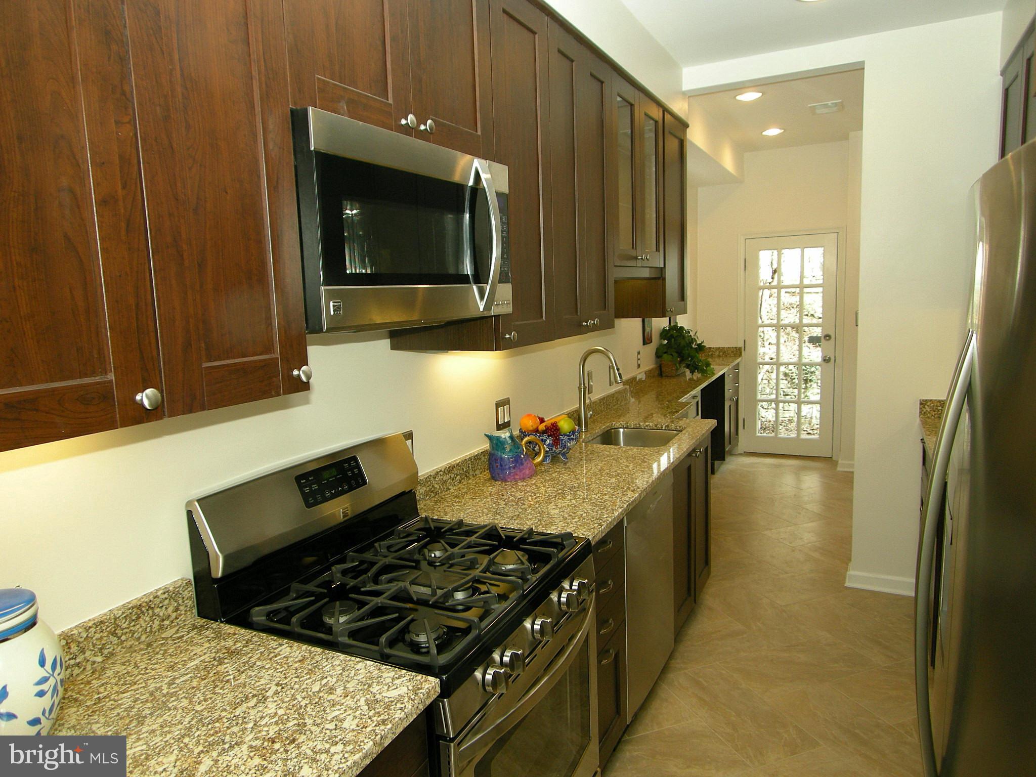 2815 Woodley Road Northwest Washington, DC 20008 - Photo 13 of 25 a kitchen with a stove and a microwave