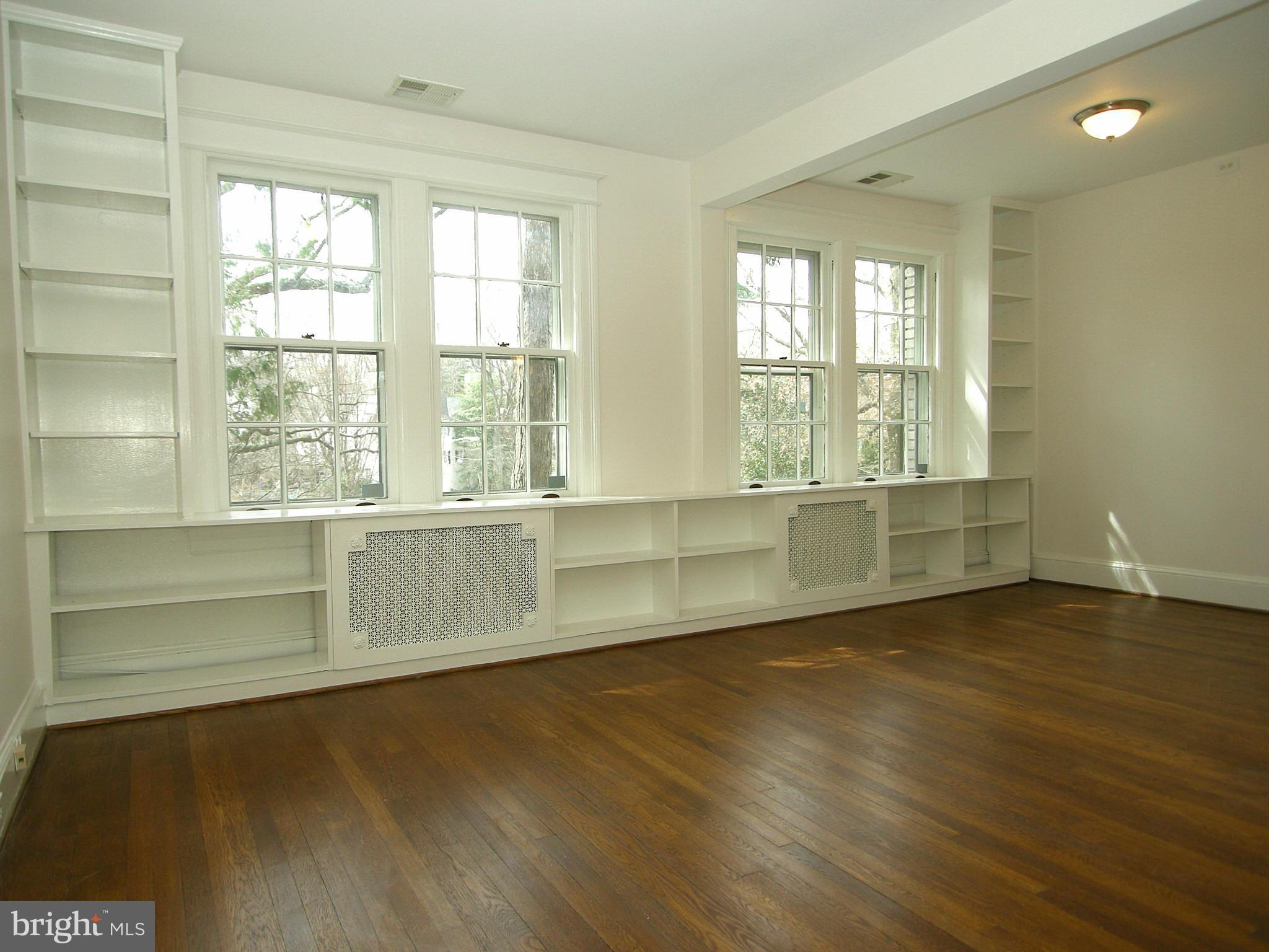2815 Woodley Road Northwest Washington, DC 20008 - Photo 14 of 25 a view of an empty room with wooden floor and a window